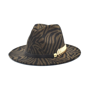 Detail of olive zebra print fedora featuring black leather band and gold feather charm