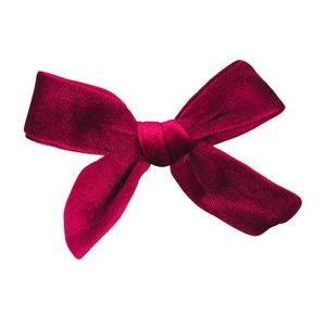 Close-up of deep red velvet bow tie showing rich fiber texture and knot detail