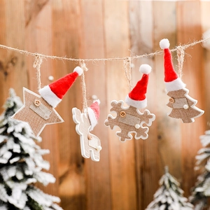 Set of four wooden Christmas ornaments featuring star, elk, snowflake, and tree shapes