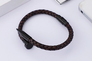 Close-up of woven dark brown leather cord bracelet with black stainless steel nail clasp