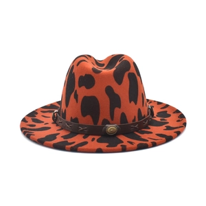 Orange cow print felt fedora hat with wide brim and decorative faux leather band
