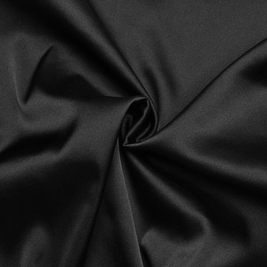 Detailed view of black satin fabric showing smooth texture and light reflection