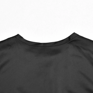 Close-up of black satin crop top back neckline with smooth silk texture and neat stitching