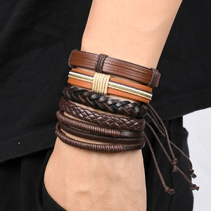 Close-up of vintage multi-layer braided leather bracelets worn on a male wrist