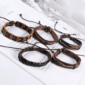 Detailed view of five-piece set brown vintage braided leather and cord bracelets for men