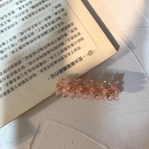 Close-up of pink gummy bear hair clips with glitter finish on a metal alligator clip