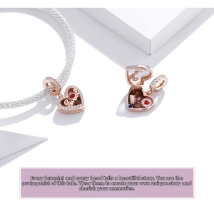 Detailed macro of openable S925 silver heart charm with Sweet engraving and enamel cake inside