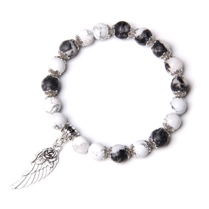 Minimalist white turquoise beaded bracelet with vintage silver wing and rose charm