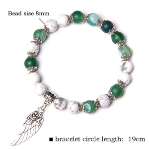Detail of 8mm green agate and white marble beads with a silver rose wing charm