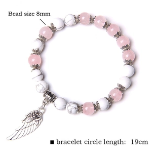 Detailed view of 8mm bead bracelet featuring pink stones and silver wing charm