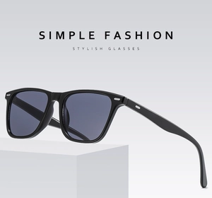 Detail of classic black square sunglasses with silver rivets on a white pedestal