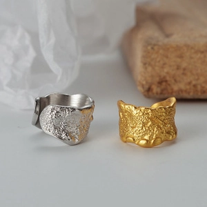 Close-up of S925 sterling silver rings with irregular lava texture in gold and silver
