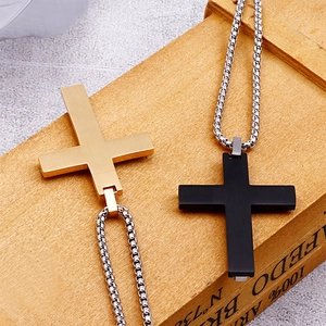 Detail of matte brushed titanium steel cross pendants in gold and black with box chains