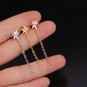 Pentagram star cartilage earrings with colorful zircon and steel screw back held on hand