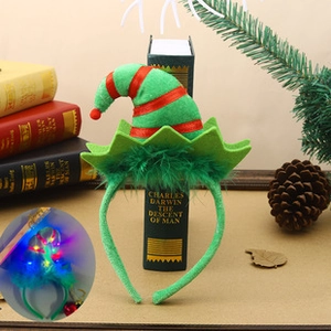 Detail of glowing Christmas headband with elf hat and feathers in a festive setup