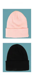 Flat lay of pink and black knit beanies showing ribbed texture and folded brim design