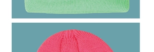 Detailed knit texture of bright green and rose pink winter beanies for kids