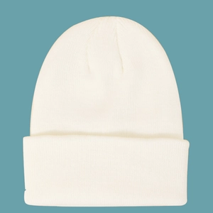 Detailed view of the fine texture on a white knit beanie with a folded cuff design