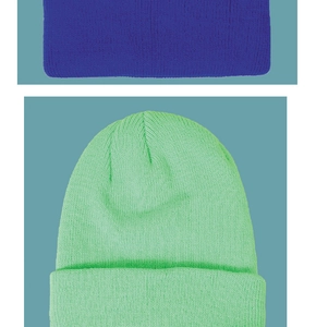 Close-up detail of fine knit texture and folded cuff on blue and neon green beanies