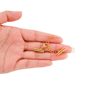 Detail of golden multi-strand connector with lobster clasp and teardrop extension chain