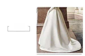 Detail of elegant white satin wedding dress train with premium glossy fabric on stone stairs