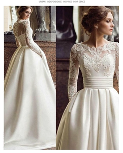 Close-up of elegant ivory lace bodice and long sheer sleeves on a satin wedding gown