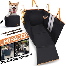 Detail view of durable black dog car seat cover with orange trim and leash accessories