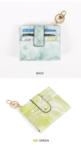 Detail view of green marble pattern card holder with gold hardware and multiple slots