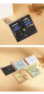 Detail view of marble pattern card holders with multiple slots and metal keychains