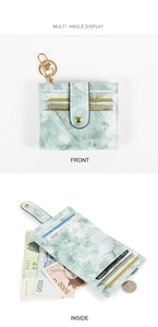 Detail view of marble pattern card holder with multiple slots and golden hardware