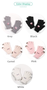 Detail display of five multi-colored knitted winter gloves with touch screen fingertips