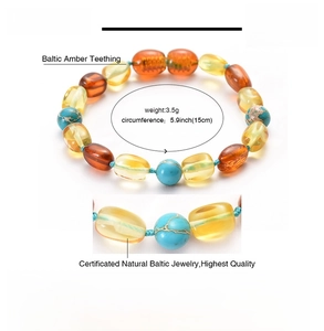 Macro shot of 15cm Baltic amber baby bracelet with turquoise beads weighing 3.5g