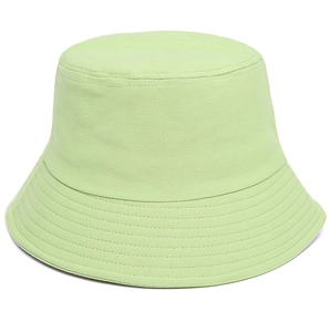 Detailed close-up of light green cotton bucket hat with parallel stitching on the brim