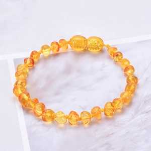 Authentic Baltic amber baby bracelet with irregular transparent yellow beads on marble