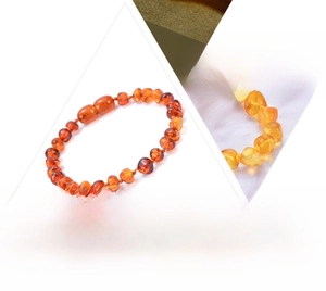 Detail of natural Baltic amber baby bracelet with safety knots and smooth beads