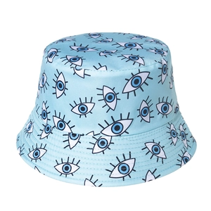 Detail view of the embroidered evil eye pattern on the light blue cotton bucket hat surface