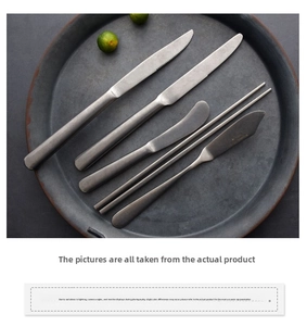 Close-up of vintage industrial style stainless steel steak knife and cutlery set