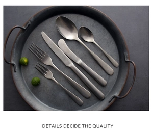 Macro shot of 6-piece matte grey cutlery set arranged on a vintage metal tray