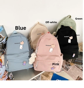 Flat lay display of cute canvas backpacks in five pastel colors with bear charms