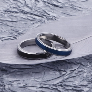 Polished stainless steel couple rings in blue and black with embedded zircon detail
