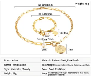 Detailed shot of golden paperclip chain set with angel pendants and white pearls