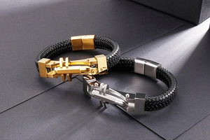 Close-up of woven leather bracelets with industrial metal buckles in gold and silver