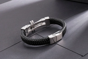 Detail of black braided leather bracelet with silver stainless steel magnetic clasp