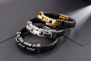 Detail of woven leather bracelets with gold, silver, and brushed steel metal clasps