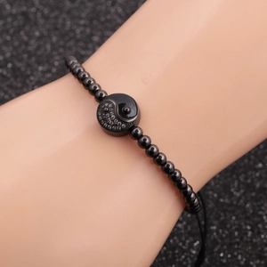 Black beaded bracelet featuring a Tai Chi Yin Yang charm with micro-pave crystals