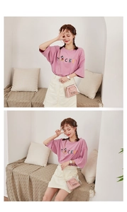 Detailed view of pink clear jelly bag with gold chain strap on casual outfit