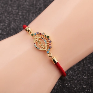 Close-up of a red woven MOM bracelet with colorful pavé cubic zirconia and adjustable chain