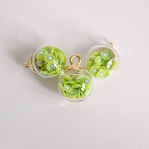 Macro shot of 16mm transparent glass ball pendants with realistic kiwi fruit slices