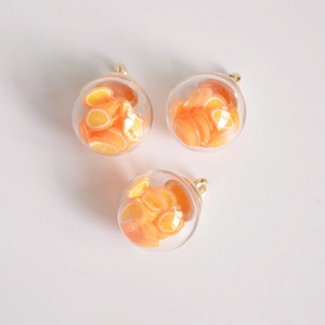 Detailed macro view of 16mm glass orb pendants featuring realistic orange fruit slices
