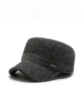 Detail view of winter flat top cap with sport badge and ear protection for men